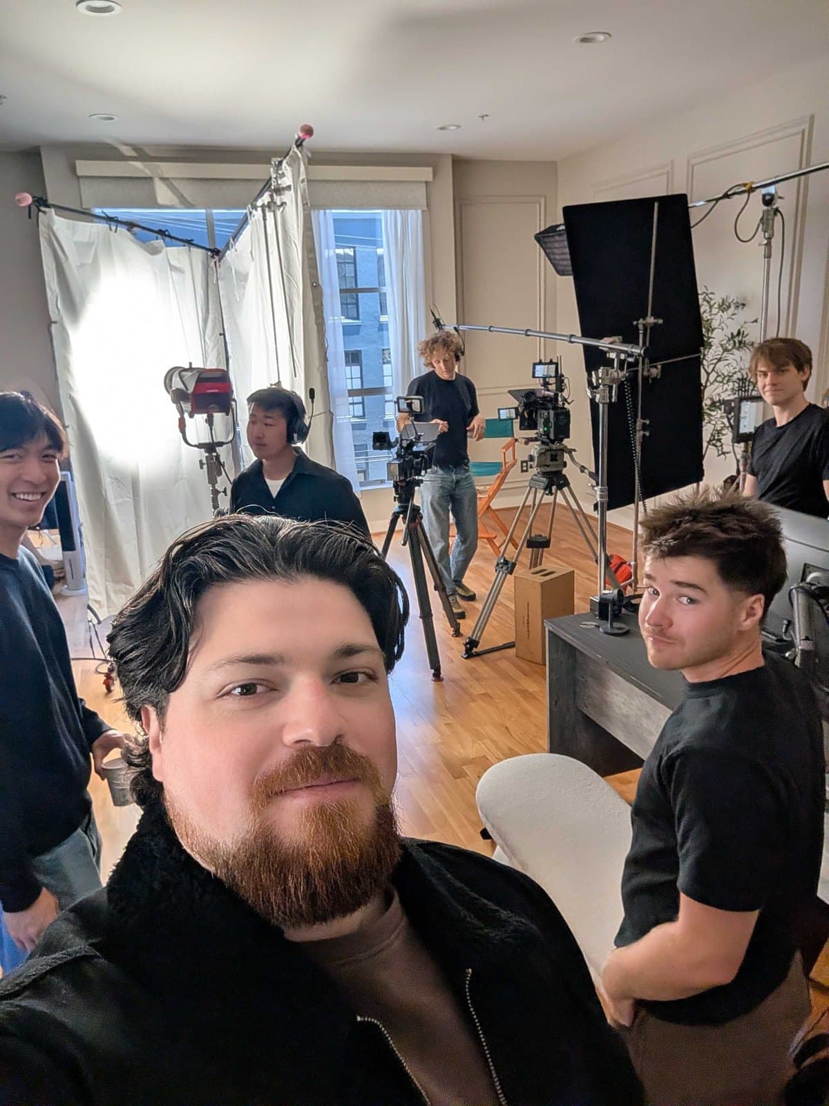 Guillaume Verdon with the film crew on set in San Francisco, cameras and lighting behind them